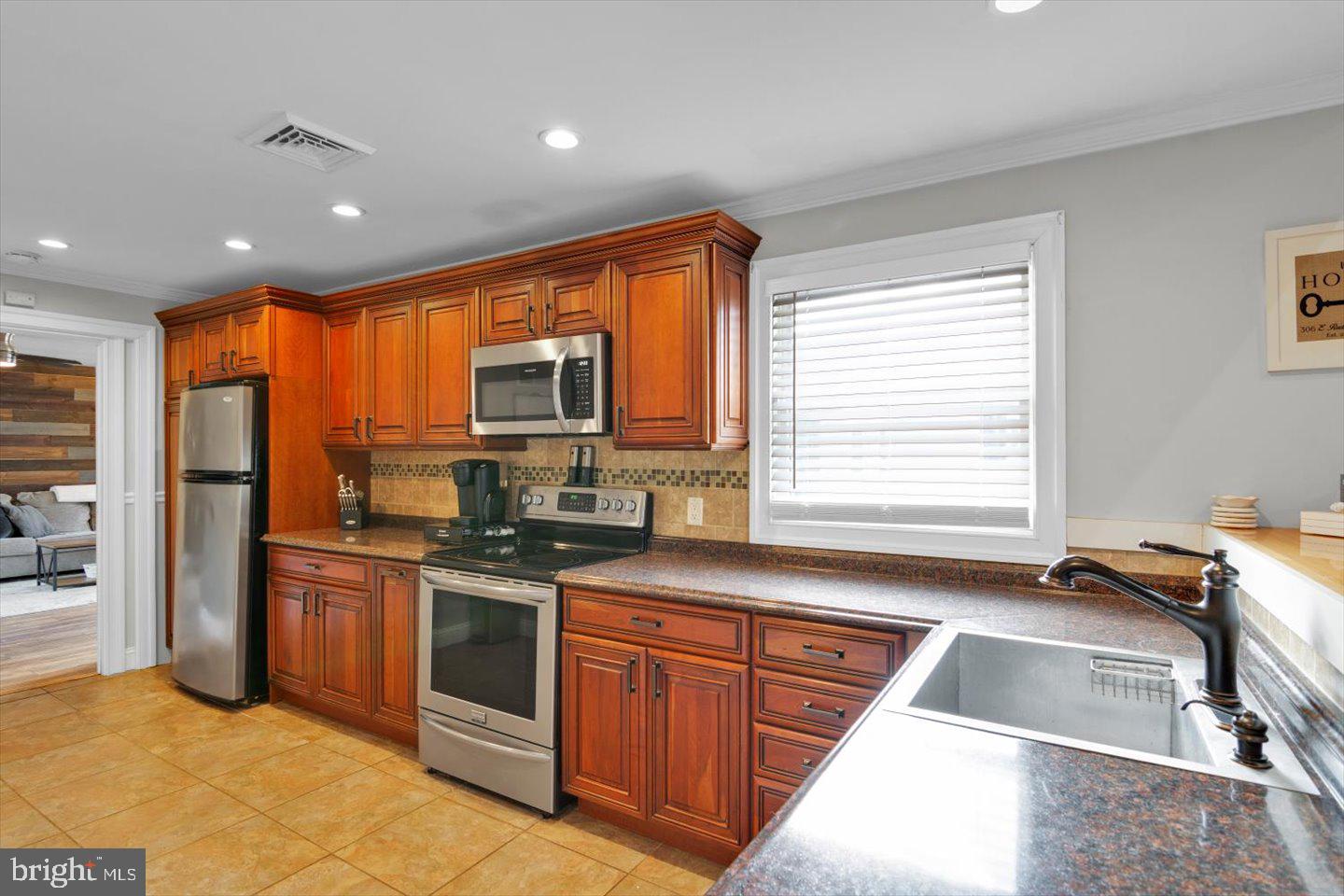 306 East Rudderow Avenue Maple Shade, NJ 08052 - Photo 12 of 38 a kitchen with stainless steel appliances granite countertop a sink stove and refrigerator