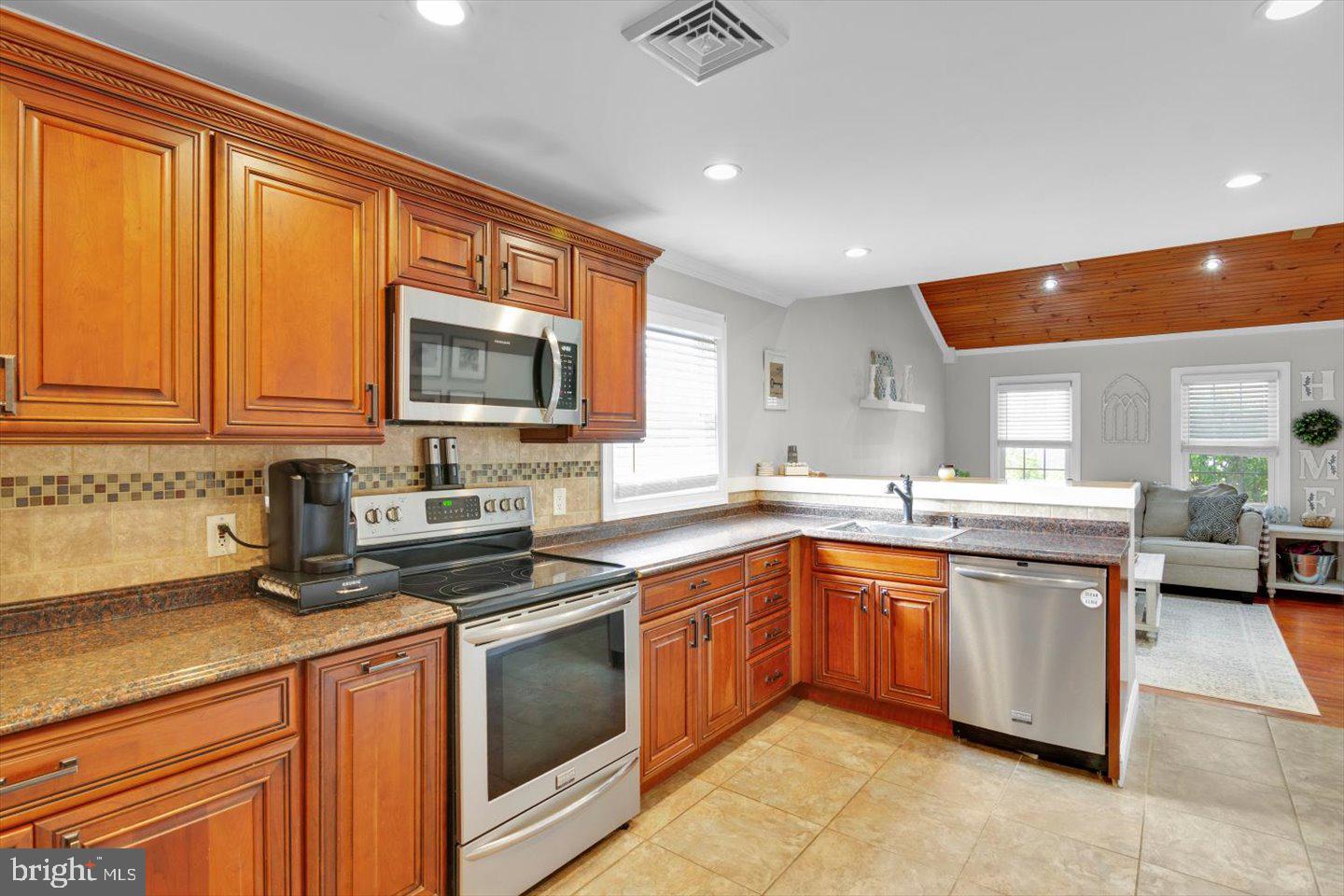 306 East Rudderow Avenue Maple Shade, NJ 08052 - Photo 13 of 38 a kitchen with stainless steel appliances granite countertop a stove sink and cabinets