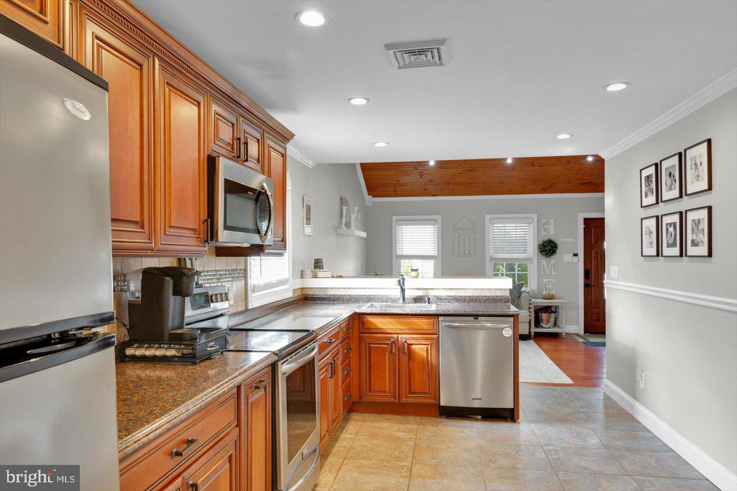 306 East Rudderow Avenue Maple Shade, NJ 08052 - Photo 14 of 38 a kitchen with a sink a counter top space stainless steel appliances and a window