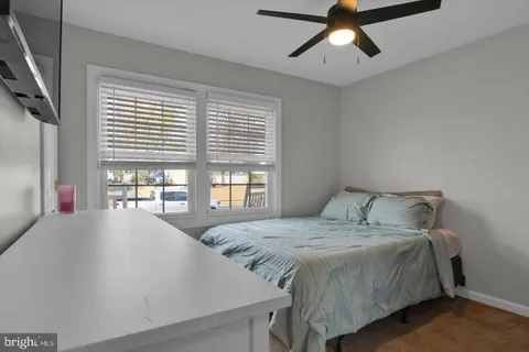 a bedroom with a large bed and a flat screen tv