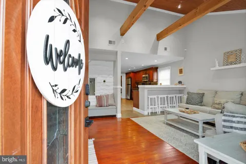 a living room with furniture and a wall painting