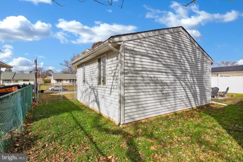 a view of a backyard with table and chairs and wooden fence