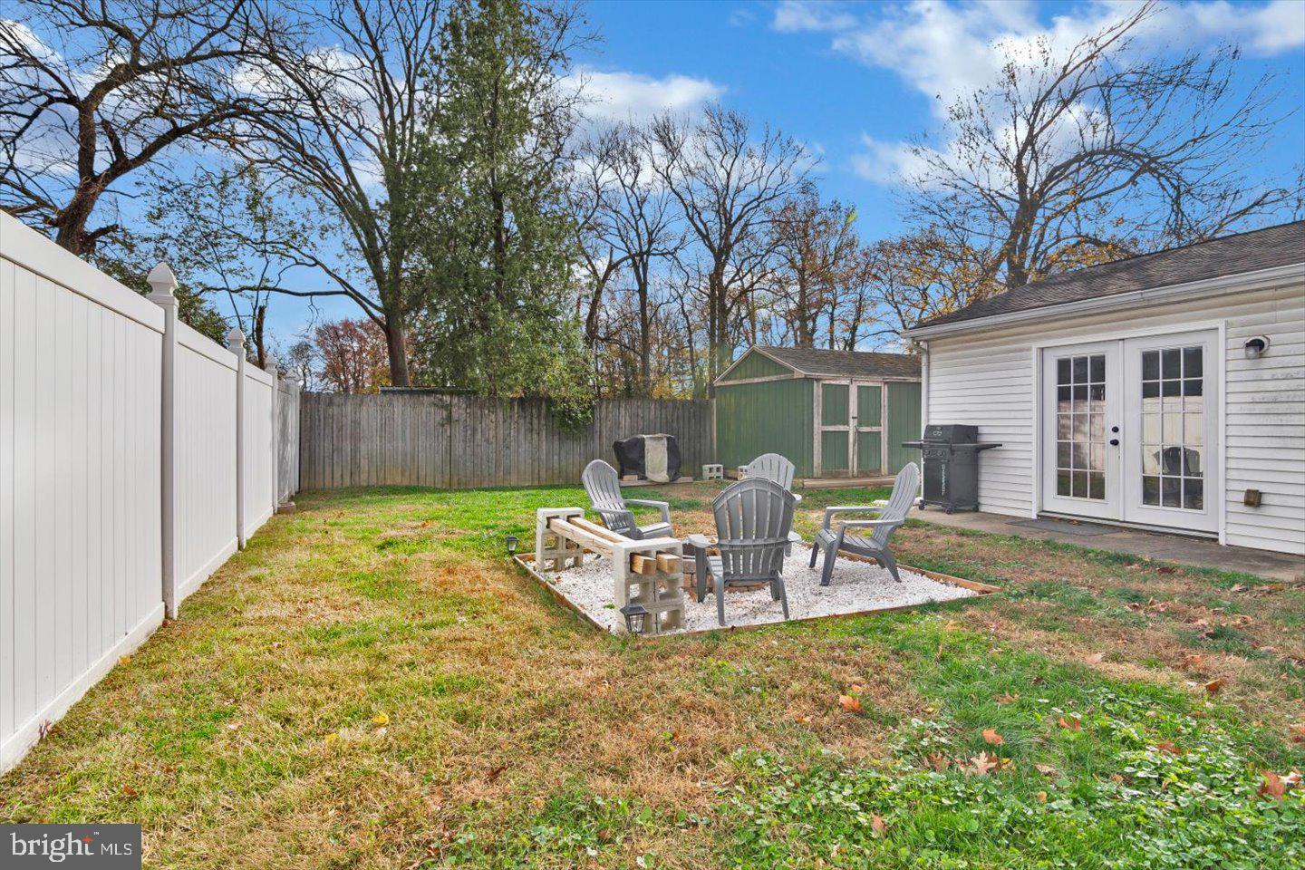 306 East Rudderow Avenue Maple Shade, NJ 08052 - Photo 35 of 38 a view of a backyard with table and chairs and wooden fence