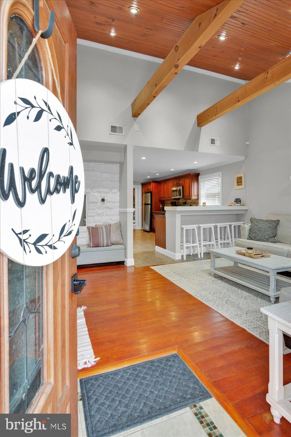 306 East Rudderow Avenue Maple Shade, NJ 08052 - Photo 4 of 38 a view of a kitchen with kitchen island a stove a wooden floor and a living room view