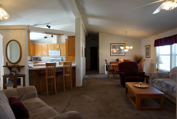 a living room with furniture a large window and a fireplace