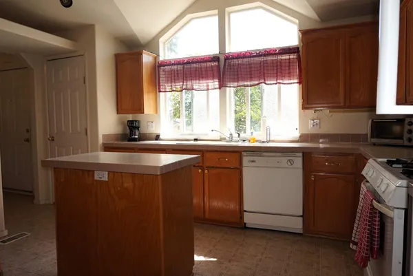 a kitchen with a sink stove and cabinets