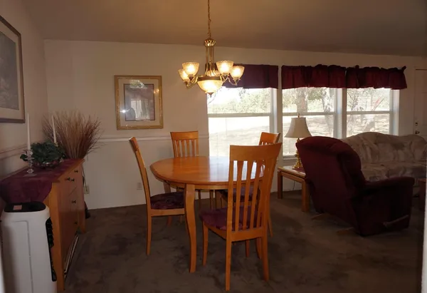 a view of a dining room with furniture window and outside view