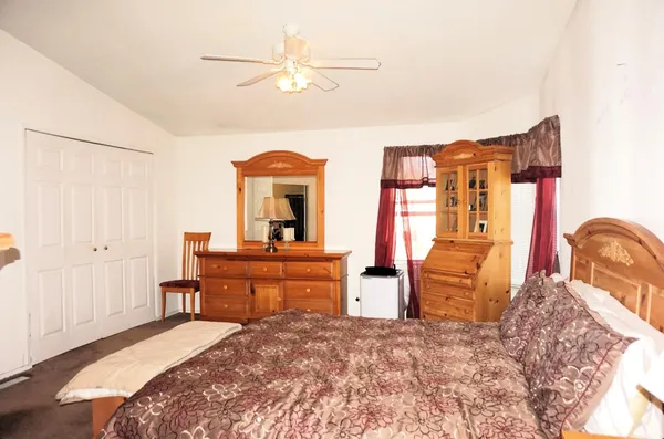 a bedroom with furniture and wooden floor