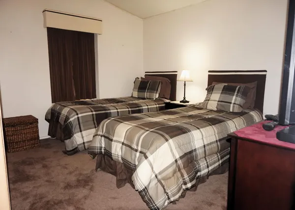 a bedroom with a bed and a mirror