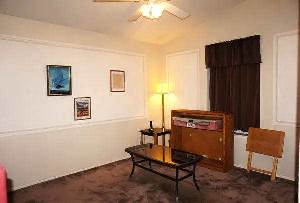 a view of a workspace with furniture and a potted plant