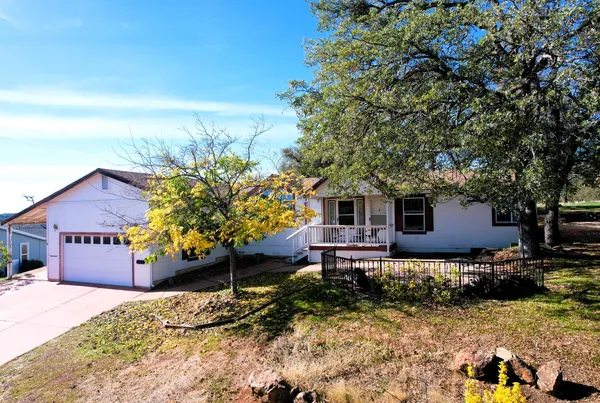a house view with a sitting space fire pit and outdoor space