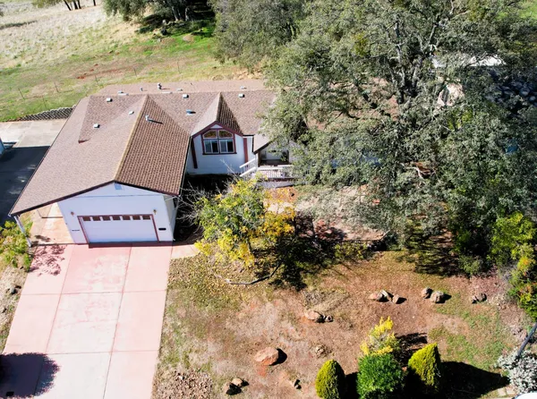an aerial view of a house with a yard