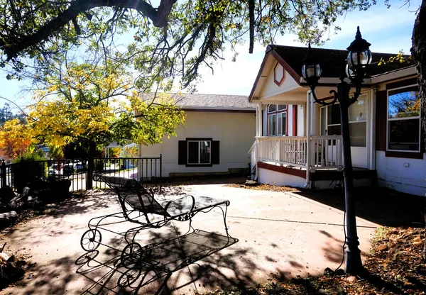 a view of house with yard outdoor seating