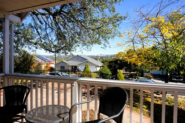 a view of a chairs and table in the balcony