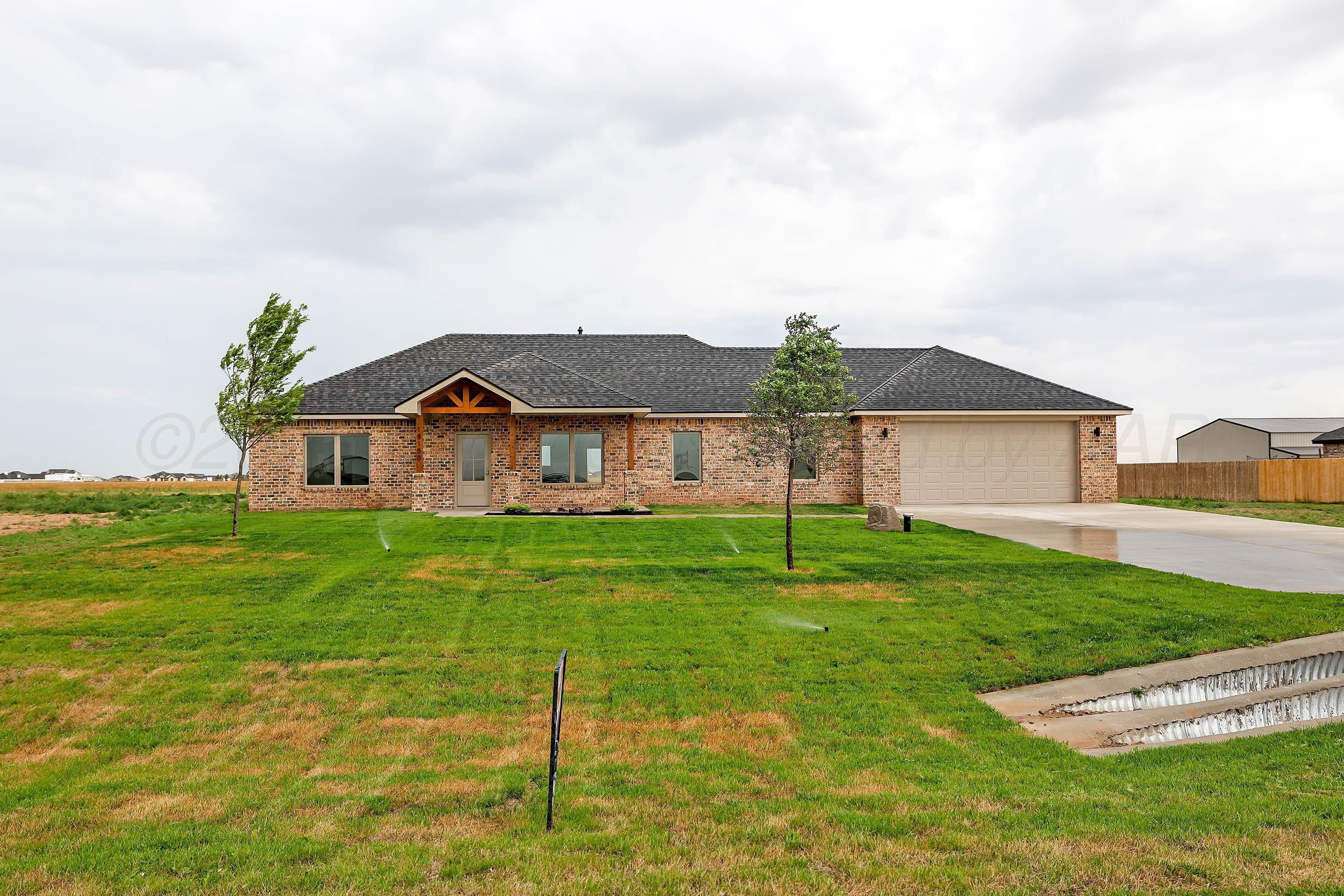 18150 Mid-Country Boulevard Amarillo, TX 79119 - Photo 1 of 25 a view of a house with a big yard potted plants and large tree