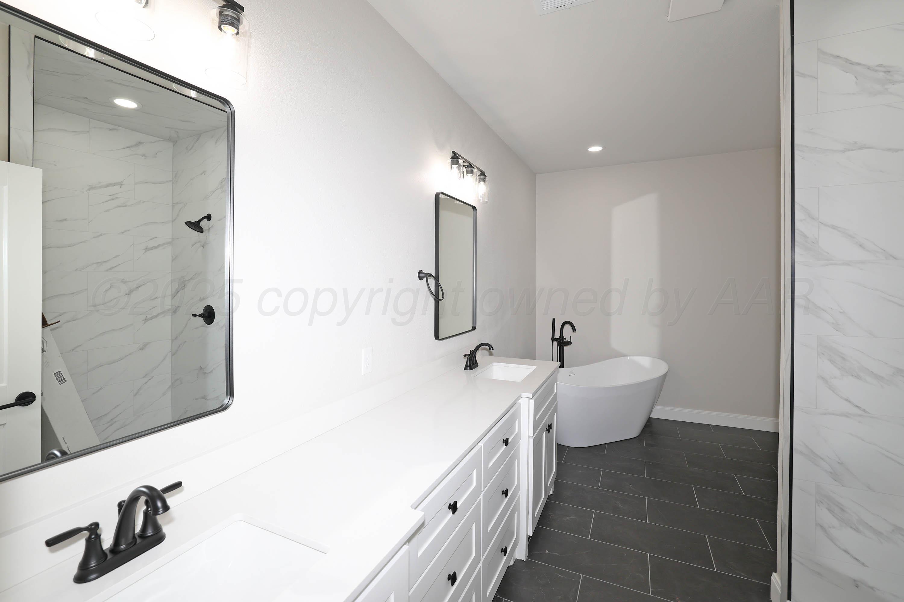 18150 Mid-Country Boulevard Amarillo, TX 79119 - Photo 12 of 25 a spacious bathroom with double vanity and mirrors