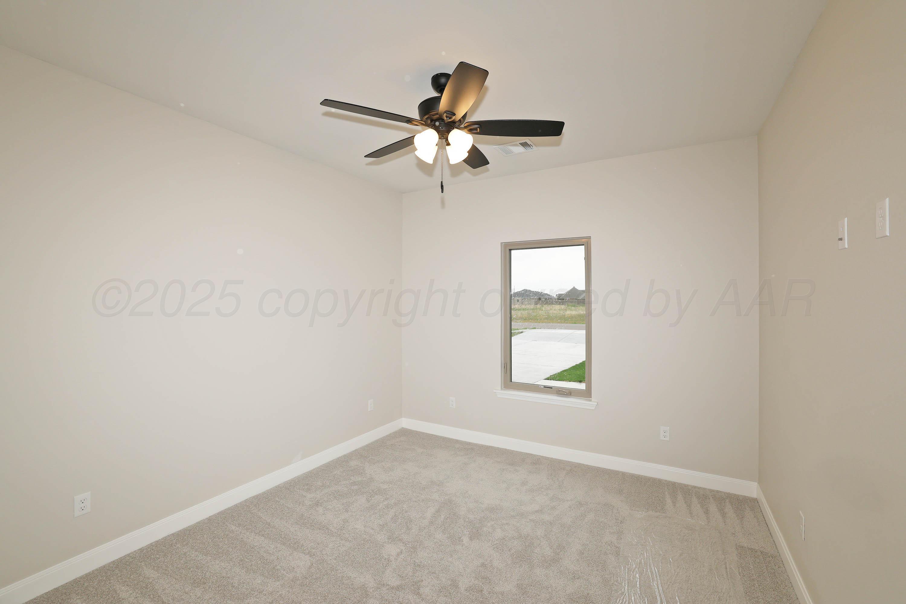 18150 Mid-Country Boulevard Amarillo, TX 79119 - Photo 17 of 25 an empty room with windows and fan
