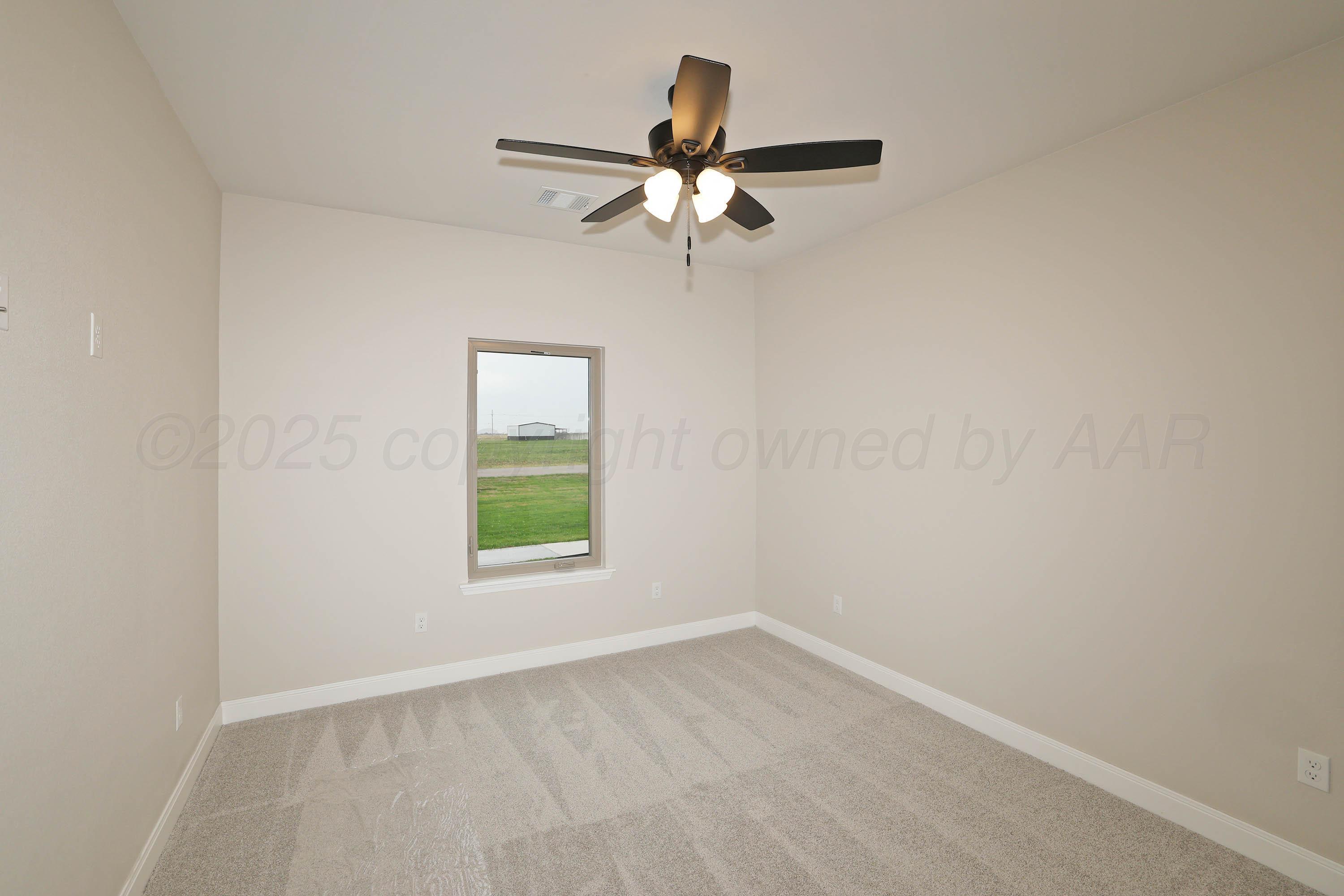 18150 Mid-Country Boulevard Amarillo, TX 79119 - Photo 19 of 25 an empty room with a window and a fan