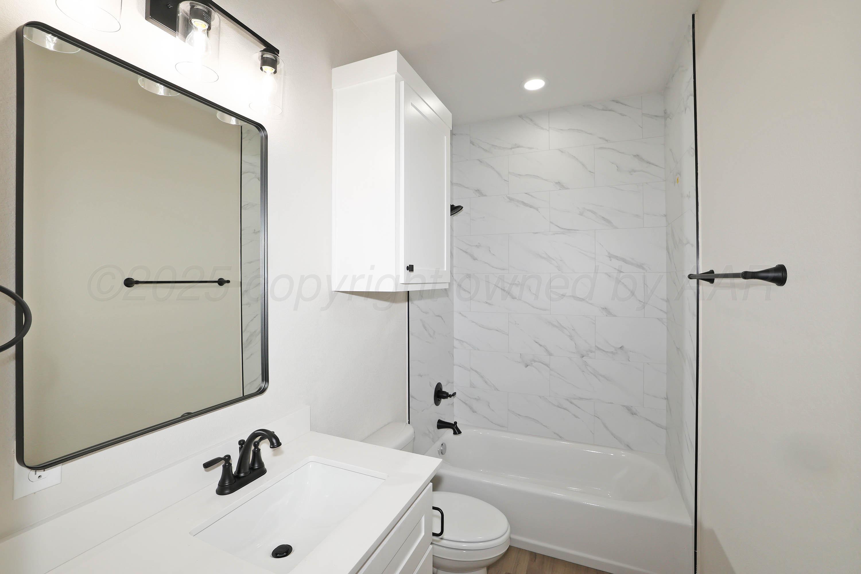 18150 Mid-Country Boulevard Amarillo, TX 79119 - Photo 21 of 25 a bathroom with a white bath tub and a sink