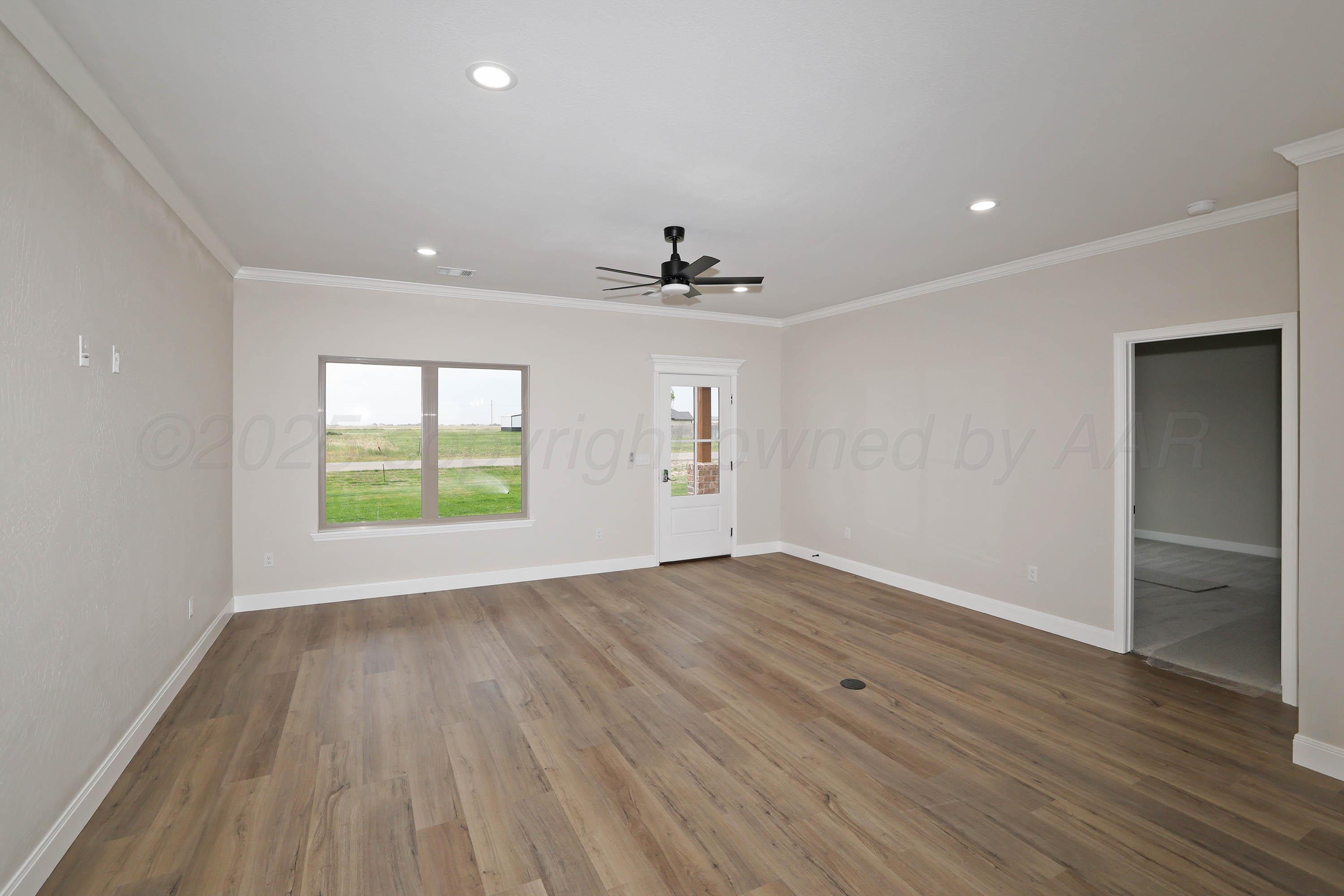 18150 Mid-Country Boulevard Amarillo, TX 79119 - Photo 5 of 25 an empty room with wooden floor and windows
