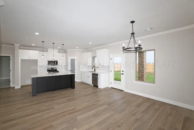 a view of kitchen with refrigerator and window