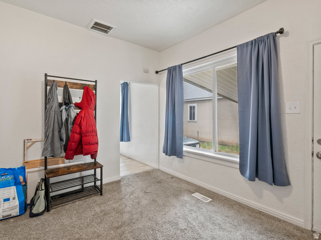 510 Canyon Road Ogden, UT 84404 - Photo 16 of 30 Empty room with baseboards and light colored carpet