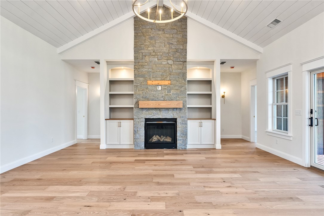 63 Forrest Lane Charlestown, RI 02813 - Photo 39 of 47 Stone gas fireplace. Custom shelves/cupboards.