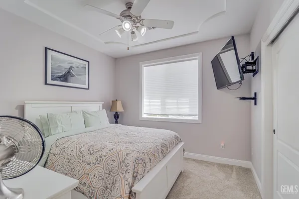 a bedroom with a large bed and a window