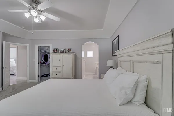 a bedroom with a bed and a chandelier