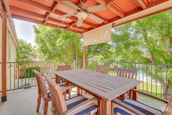 a view of a patio with table and chairs next to a yard