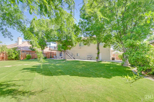a view of a backyard with large trees