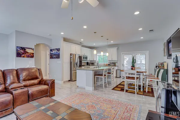 a living room with lots of furniture and kitchen view