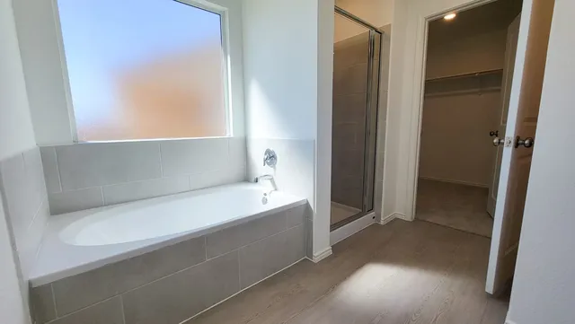 a bathroom with a bathtub and a shower