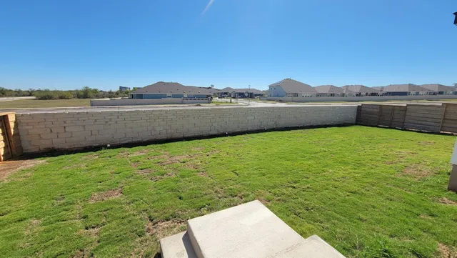 a view of a lake with houses in the background