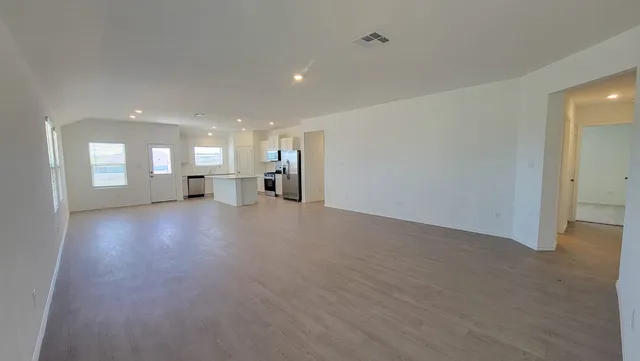 a view of a livingroom and a kitchen with furniture