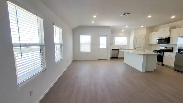 a view of kitchen with stainless steel appliances refrigerator oven and cabinets
