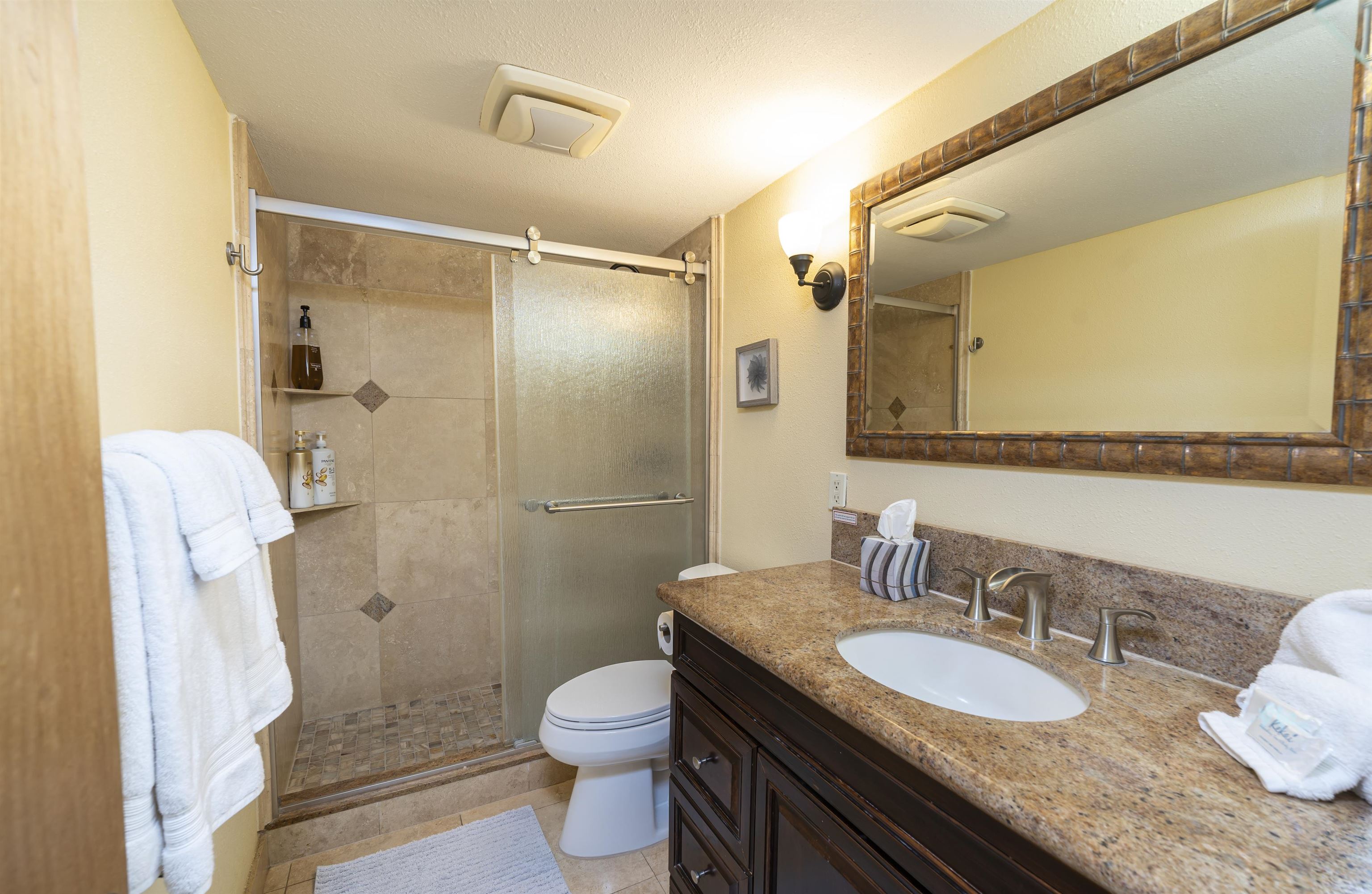 2495 South Kihei Road, Unit 137 Kihei, HI 96753 - Photo 12 of 17 a bathroom with a granite countertop sink toilet and shower