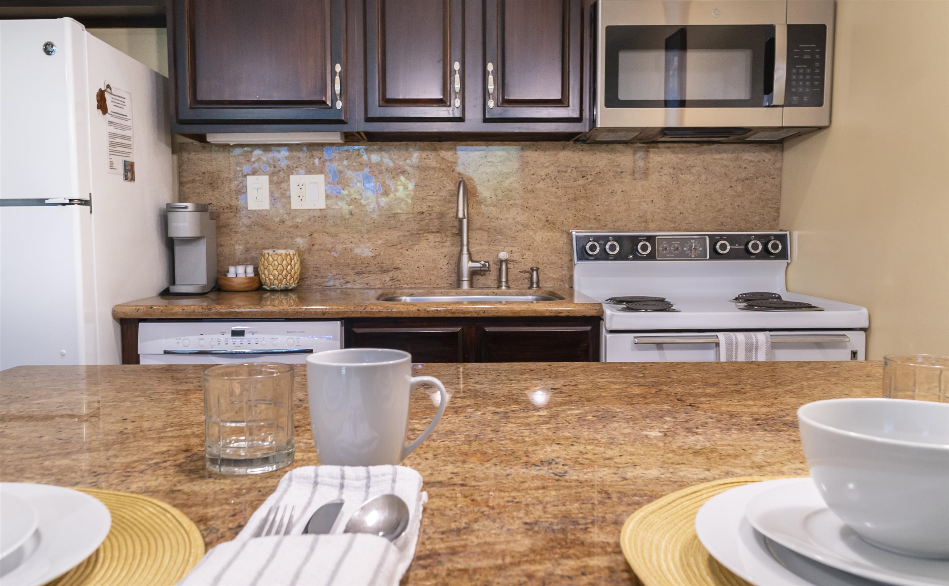 2495 South Kihei Road, Unit 137 Kihei, HI 96753 - Photo 5 of 17 a kitchen with a stove and a refrigerator