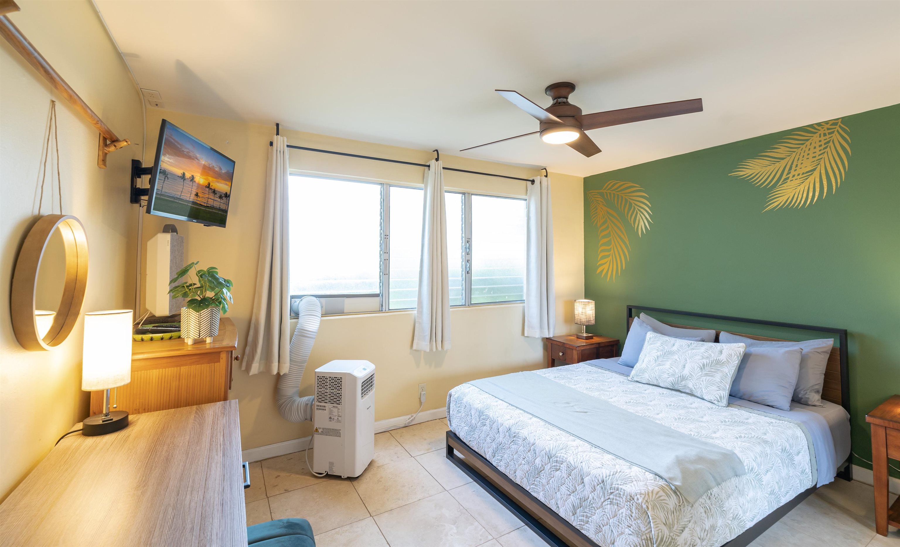 2495 South Kihei Road, Unit 137 Kihei, HI 96753 - Photo 8 of 17 a bedroom with a bed and a chandelier