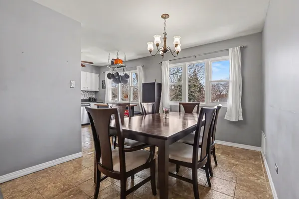 a view of a dining room with furniture window and chandelier