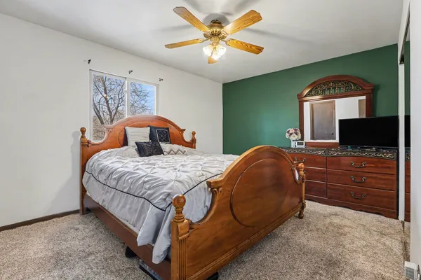 a bedroom with a bed and a television