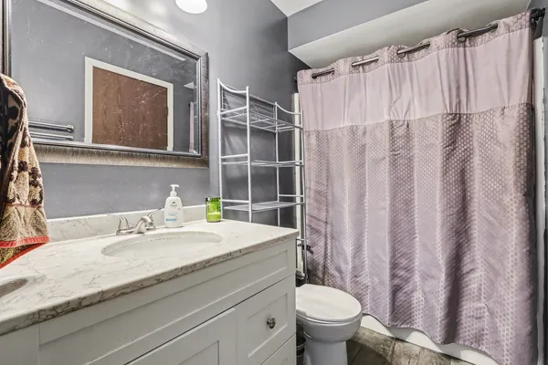a bathroom with a sink toilet and shower