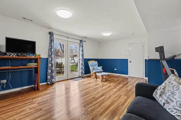 a bedroom with furniture and a flat screen tv
