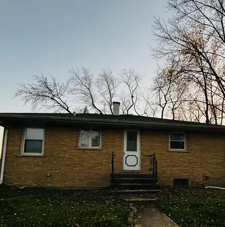 a side view of a house with a yard