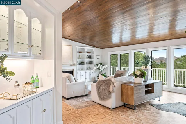 a living room with furniture and a floor to ceiling window