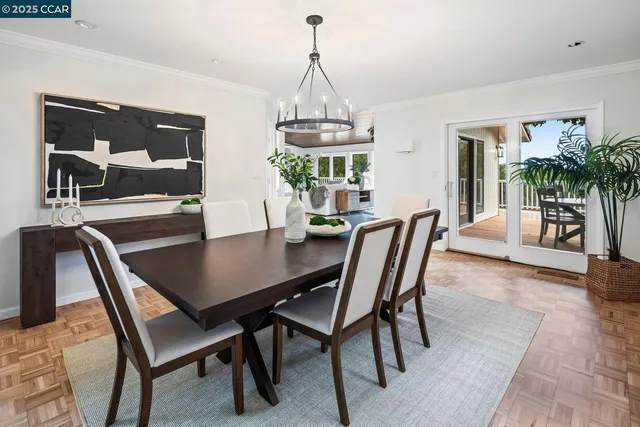 a dining room with furniture a chandelier and window