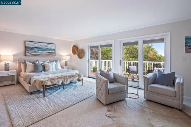 a bedroom with furniture and a large window