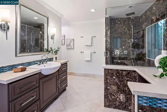 a bathroom with a tub sink and mirror