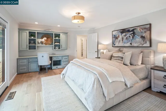 a spacious bedroom with a large bed and a chandelier