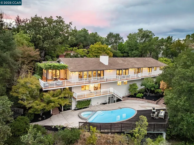 an aerial view of a house roof deck and outdoor seating